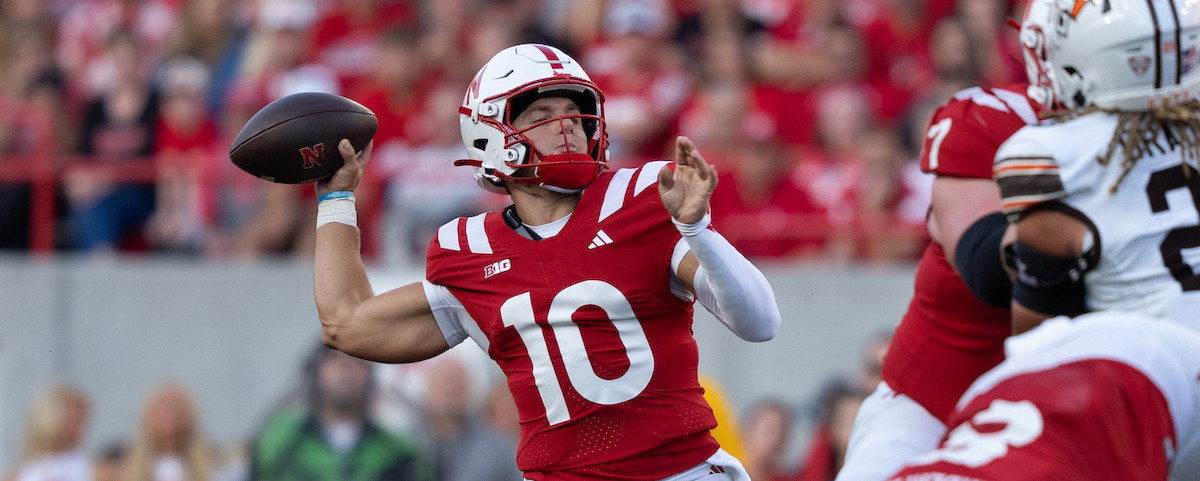 A football player competes during a game on an outdoor field.